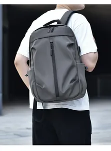 Outdoor shot of the minimalist grey-green waterproof nylon backpack with side pockets