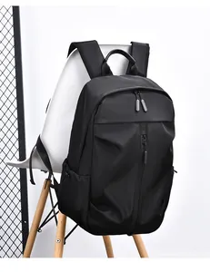 Detail view of a black waterproof nylon backpack featuring hidden zippers and side pockets