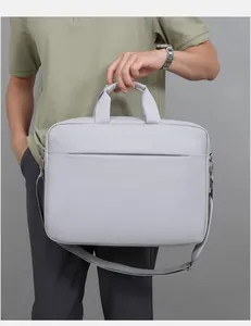 Detailed view of light gray laptop bag featuring durable fabric and detachable shoulder strap