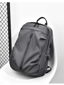 Detail of grey waterproof nylon backpack with USB port leaning on white chair