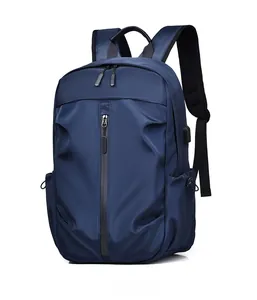 Detail of navy blue water-resistant backpack showing side USB port and durable fabric