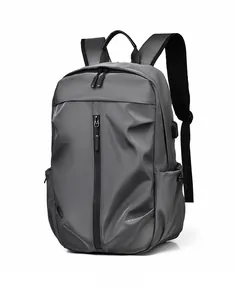 Detail view of the side USB charging port on this gray large capacity travel backpack