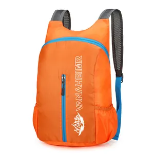 Lightweight orange folding backpack with Vanaheimr logo for hiking and outdoor sports