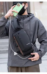 Detail of multi-functional black chest bag featuring anti-theft lock and USB charging port