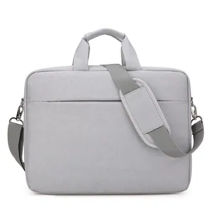 Minimalist light gray fabric laptop bag with top handles and adjustable shoulder strap