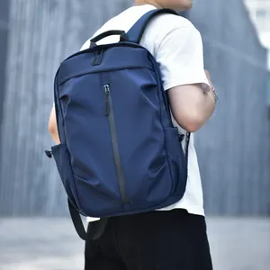 Navy blue waterproof nylon laptop backpack for men, ideal for outdoor travel and daily commute