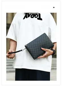 Close-up of black checkered embossed leather clutch bag with silver metal zipper detail
