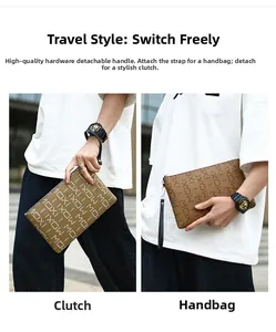 Detail of brown leather men's clutch featuring MOXI print and detachable wrist strap