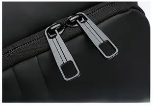 Close-up of dual metal zippers and smooth waterproof fabric on the anti-theft chest bag