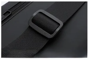 Detail of adjustable black nylon shoulder strap with a durable plastic buckle and zipper
