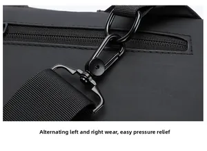 Detail of the swivel metal hook and nylon strap on a black anti-theft sling bag