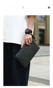 Detail of grey patterned men's clutch bag with leather wrist strap and zip closure