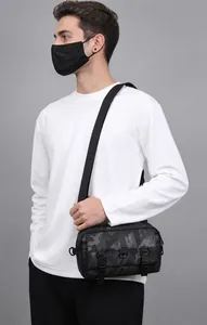 Detail view of stylish camouflage messenger bag with dual buckles and adjustable strap