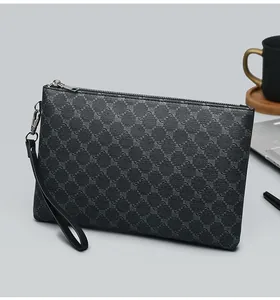 Detail view of dark grey business clutch bag with geometric print and silver zipper