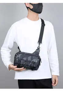 Detail showing camouflage crossbody bag with dual buckles on adjustable nylon strap