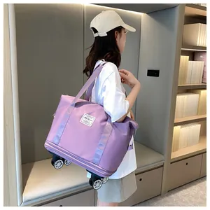 Detail of purple waterproof travel bag with spinner wheels and expandable zipper side