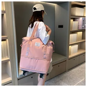 Close-up of pink waterproof nylon travel bag with universal wheels and sturdy handles