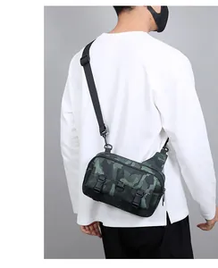 Close-up of camouflage messenger bag featuring dual buckle straps and adjustable nylon belt
