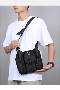 Detail view of black tactical crossbody bag with multiple utility pockets and adjustable strap