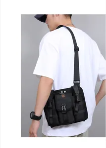 Tactical black nylon shoulder bag with buckle pockets and adjustable strap shown on model