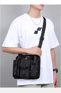 Side view of black tactical crossbody bag with nylon webbing and buckle on a male model