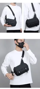 Detail view of black tactical crossbody bag with adjustable strap on male model