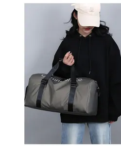 Détail du sac de sport gris-vert avec logo Commonplace blanc et poignées renforcées