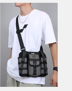 Tactical chest bag with Molle webbing and adjustable strap worn on a white t-shirt