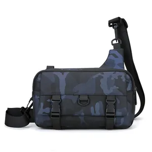 Detail of blue camo crossbody bag with dual buckles and metal D-ring for hiking