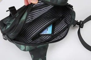Detail view of the camouflage crossbody bag featuring striped lining and interior zip pocket