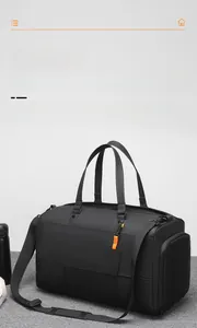 Detail of black gym bag with shoe compartment, wide shoulder strap and water bottle