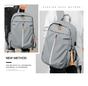 Detailed view of gray waterproof backpack showing handheld and shoulder carry versatility