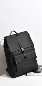 Detailed view of black flap backpack with metal buckle and premium matte waterproof texture