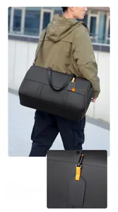 Detail of a black travel bag featuring a stylish luggage tag and matte synthetic leather