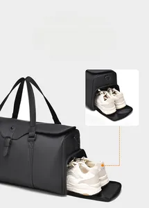 Detail view of the waterproof travel bag featuring a dedicated ventilated shoe compartment