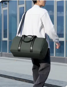 Detailed view of olive green travel bag with adjustable strap and side zipper pocket