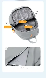 Internal view of grey waterproof backpack showing striped lining and padded laptop compartment