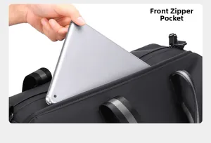Front zipper pocket of a black travel bag holding a tablet for easy access