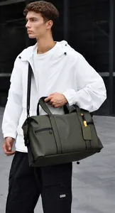 Detail of army green travel bag with reinforced handles and orange buckle strap