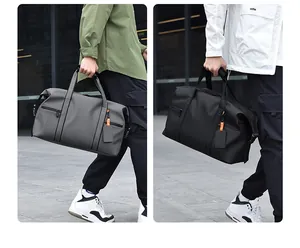 Detail of grey and black large capacity travel bags with waterproof fabric and side pockets