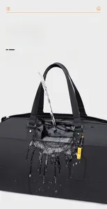Detailed view of large black travel bag showing professional waterproof fabric performance