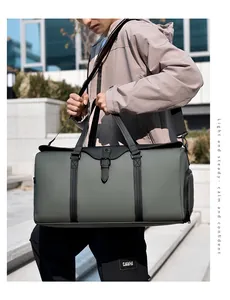 Detail of waterproof olive green travel bag with black handles and metal buckle