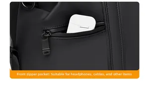 Close-up of front zipper pocket on travel bag storing a small white earphone case