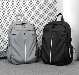 Detail view of grey and black waterproof backpacks featuring side USB charging port