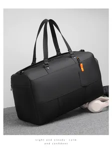 Close-up of black leather travel bag with high-quality matte texture and orange tag
