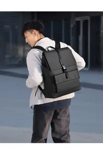 Detail of waterproof black flap backpack with buckle strap on male model outdoors
