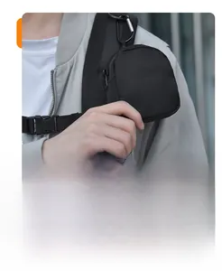 Close-up of a small nylon strap pouch for earphones and cables on a black backpack