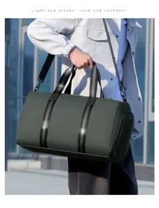 Detail of waterproof dark green travel bag showing shoe compartment and shoulder strap