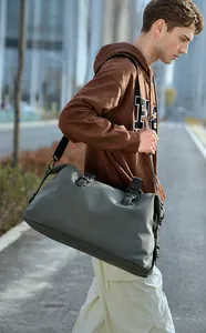 Macro detail of olive green waterproof nylon travel duffel with adjustable black strap