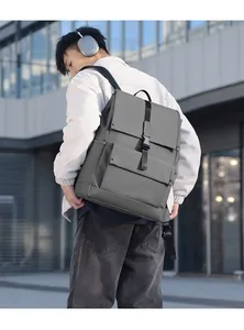Detail of grey commuter backpack featuring flap closure and premium metal buckle detail